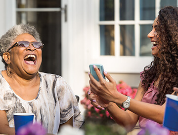 Two women laughing while using a smartphone from U.S. Cellular